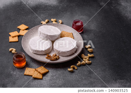 Brie or Camembert cheese is a white, round shape for baking and melting. Camembert cheese Brie or Camembert cheese is a white, round shape for baking and melting. Camembert cheese 140903525