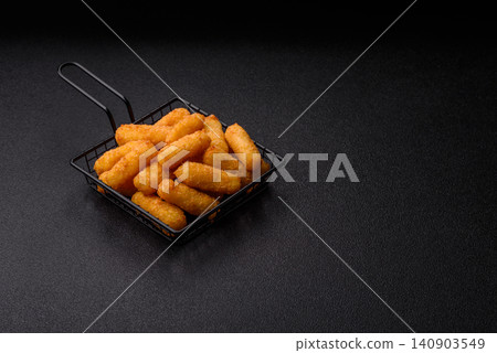 Mozzarella cheese sticks, breaded and fried with salt and tomato sauce, for takeaway. Cheese sticks Mozzarella cheese sticks, breaded and fried with salt and tomato sauce, for takeaway. Cheese sticks 140903549