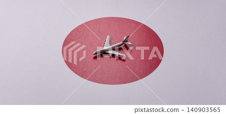 An airplane on the japanese flag as a conceptual backdrop. An airplane on the japanese flag An airplane on the japanese flag as a conceptual backdrop. An airplane on the japanese flag 140903565