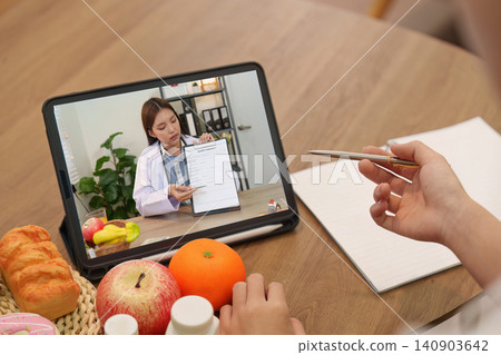 Patient having online consultation with doctor on tablet for telehealth medical advice Patient having online consultation with doctor on tablet for telehealth medical advice 140903642