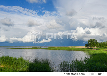 Dramatic Cloudscape Over Lake Liepaja Wetlands and Reeds in Summer Landscape of Western Latvia 140903845