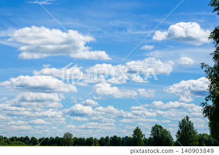 Scenic summer sky with white cumulus clouds above green forest landscape in rural Latvia nature panorama Scenic summer sky with white cumulus clouds above green forest landscape in rural Latvia nature panorama 140903849