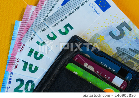 Euro Banknotes and Credit Cards in Black Leather Wallet on Yellow Background Close Up Financial Concept Euro Banknotes and Credit Cards in Black Leather Wallet on Yellow Background Close Up Financial Concept 140903856