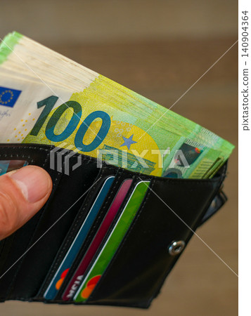Black Leather Wallet with 100 Euro Banknotes and Payment Cards Personal Finance and Savings concept Black Leather Wallet with 100 Euro Banknotes and Payment Cards Personal Finance and Savings concept 140904364