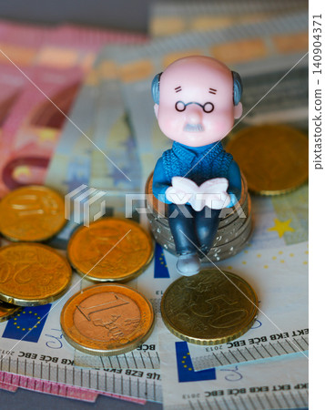 Senior Figurine on Euro Coins with Banknotes Illustrating Pension Savings and Retirement Finance Today Senior Figurine on Euro Coins with Banknotes Illustrating Pension Savings and Retirement Finance Today 140904371