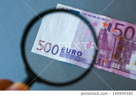 Magnifying Glass Inspecting 500 Euro Banknote Symbolizing Money Verification and Counterfeit Detection Magnifying Glass Inspecting 500 Euro Banknote Symbolizing Money Verification and Counterfeit Detection 140904380
