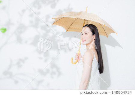 A woman holding a parasol A woman holding a parasol 140904734