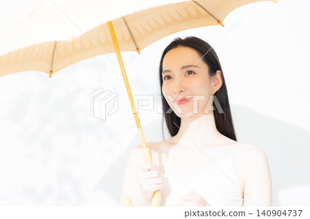 A woman holding a parasol A woman holding a parasol 140904737