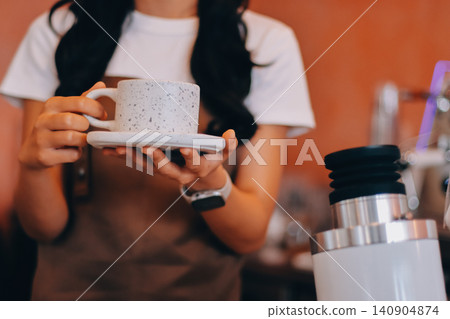Young woman at barista school learning how to make espresso coffee. Young woman at barista school learning how to make espresso coffee. 140904874