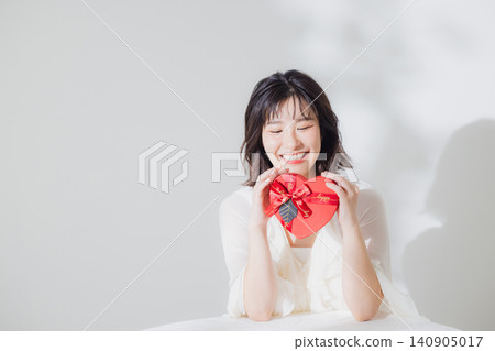 A woman giving a gift A woman giving a gift 140905017