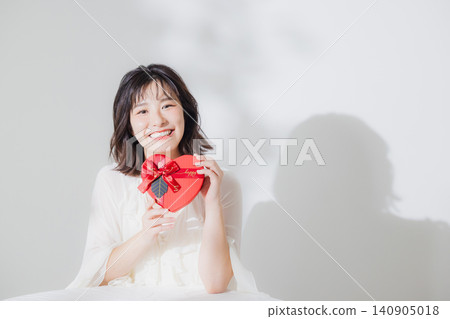 A woman giving a gift A woman giving a gift 140905018