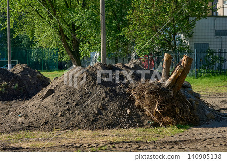 Pile debris garbage.Remove earthen ground before laying asphalt Pile debris garbage.Remove earthen ground before laying asphalt 140905138