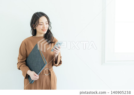 Business woman with a smartphone Business woman with a smartphone 140905238