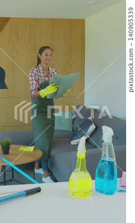 Vertical Video Positive smiling professional cleaners doing cleanup in ordinary apartment. Vertical Video Positive smiling professional cleaners doing cleanup in ordinary apartment. 140905339