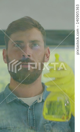 Vertical Video Man removing cleaning solution from glass with special tool, cleaning service. Vertical Video Man removing cleaning solution from glass with special tool, cleaning service. 140905363