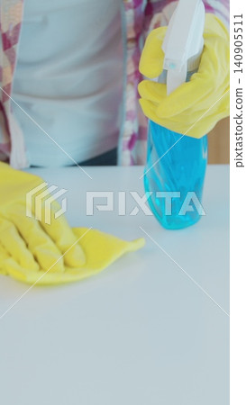 Vertical Video Cleaning the kitchen. Housekeeper washes the kitchen table. Vertical Video Cleaning the kitchen. Housekeeper washes the kitchen table. 140905511