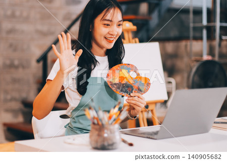 Female artist wears black hat posing near picture indoor the studio 140905682