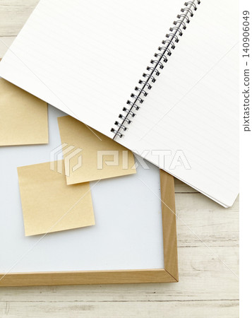 Business thought organization and task management: Ring notebook, wooden frame whiteboard, and craft sticky notes. Business thought organization and task management: Ring notebook, wooden frame whiteboard, and craft sticky notes. 140906049