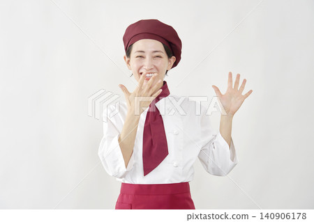 The pastry chef woman smiles in surprise. 140906178