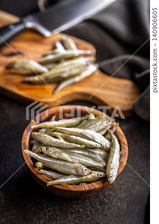 Bowl Of Fresh Small Fish On Wooden Bowl Rustic Seafood Ingredients For Cooking Bowl Of Fresh Small Fish On Wooden Bowl Rustic Seafood Ingredients For Cooking 140906605