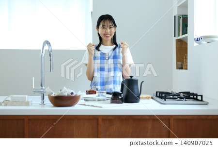 A woman's kitchen: Cooking image A woman's kitchen: Cooking image 140907025
