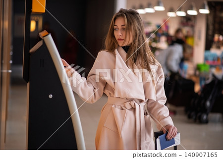 Young woman at self service transfer area. Young woman at self service transfer area. 140907165