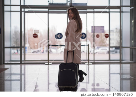 Woman with a suitcase goes to exit the station. Woman with a suitcase goes to exit the station. 140907180
