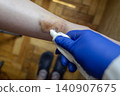 Doctor in blue gloves treating a large bruise and hematoma on a child leg. Medical care, first aid and treatment for pediatric skin injury or contusion. Doctor in blue gloves treating a large bruise and hematoma on a child leg. Medical care, first aid and treatment for pediatric skin injury or contusion. 140907675