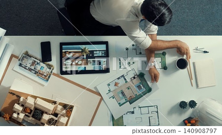 Top down view of civil engineer talking to manager by using phone. Alimentation. Top down view of civil engineer talking to manager by using phone. Alimentation. 140908797