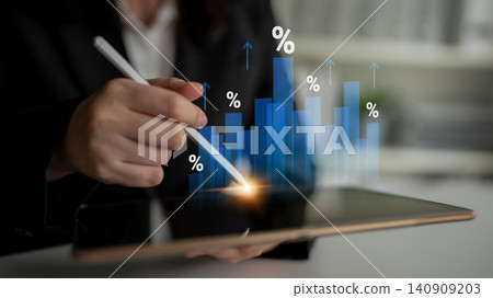 Business professional analyzing data trends on a tablet with digital graphs showing growth percentages and market fluctuations in a modern office setting Cyphers. Business professional analyzing data trends on a tablet with digital graphs showing growth percentages and market fluctuations in a modern office setting Cyphers. 140909203