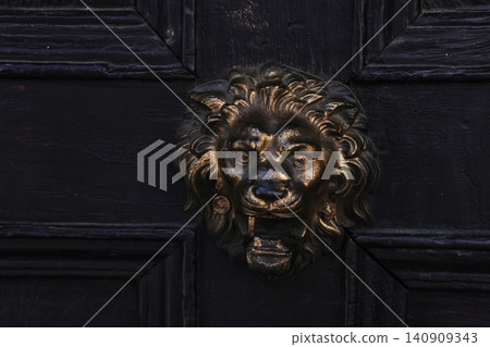 Vintage Lion Door Knocker on Wooden Door for Classic Architectural Decor Vintage Lion Door Knocker on Wooden Door for Classic Architectural Decor 140909343