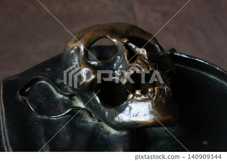 Ancient Bronze Skull Sculpture Portraying Mortality for Artistic Reflection Ancient Bronze Skull Sculpture Portraying Mortality for Artistic Reflection 140909344