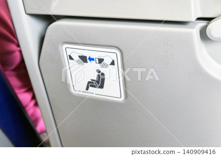 Airplane Safety Instruction Sign with Folding Tray Table in Focus for In-Flight Guidance and Passenger Safety 140909416