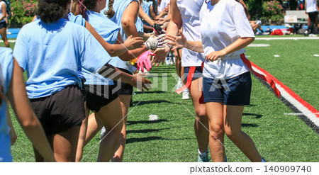 Girls Play Flag Football and Shake Hands on the Field after a Game Girls Play Flag Football and Shake Hands on the Field after a Game 140909740