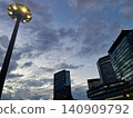 A night view of Osaka's business district, with its cluster of skyscrapers bathed in the twilight light. 140909792