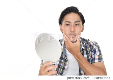 A man with a hand mirror A man with a hand mirror 140909864
