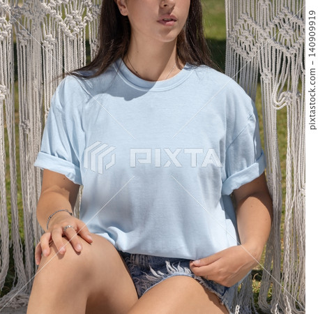 Blank light blue shirt mockup, young woman outdoors on a sunny day, front view with copy space Blank light blue shirt mockup, young woman outdoors on a sunny day, front view with copy space 140909919