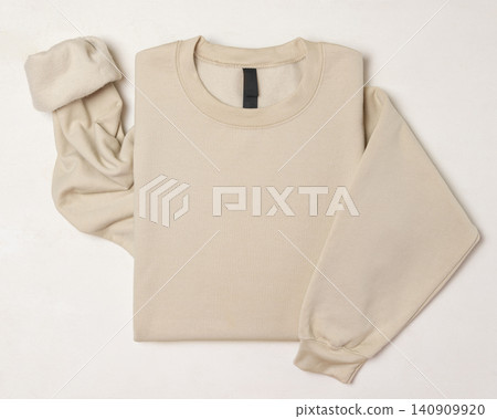 Blank beige unisex sweatshirt mockup, folded apparel template, copy space on front and sleeve Blank beige unisex sweatshirt mockup, folded apparel template, copy space on front and sleeve 140909920