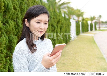 Woman with smartphone Woman with smartphone 140910037
