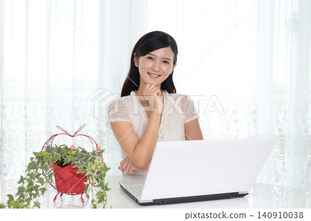 A woman enjoying a laptop computer A woman enjoying a laptop computer 140910038