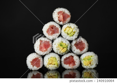 Delicious sushi rolls on black mirror surface Delicious sushi rolls on black mirror surface 140910064