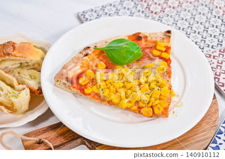 Corn and tomato sauce pizza with basil Corn and tomato sauce pizza with basil 140910112