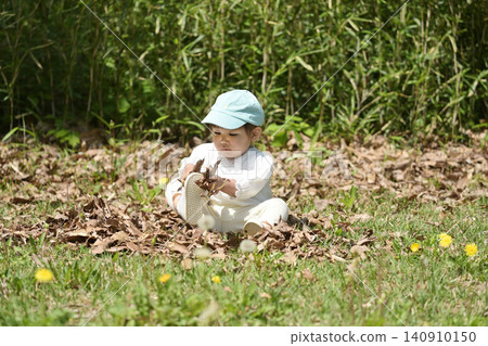 Small children playing with fallen leaves Small children playing with fallen leaves 140910150