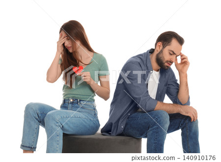 Woman with torn paper heart near her boyfriend on white background. Relationship problems Woman with torn paper heart near her boyfriend on white background. Relationship problems 140910176