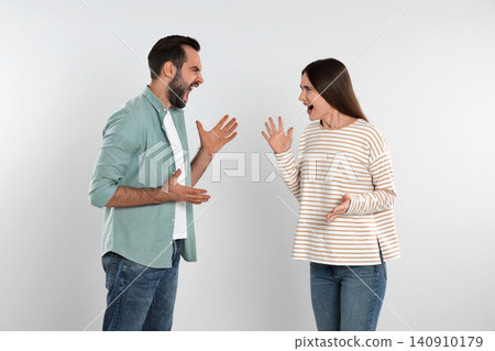 Couple quarreling on light background. Relationship problems Couple quarreling on light background. Relationship problems 140910179