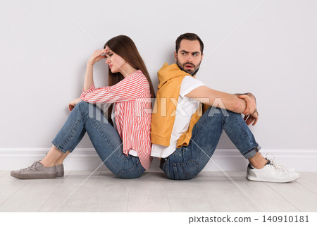 Unhappy young couple with relationship problems indoors Unhappy young couple with relationship problems indoors 140910181