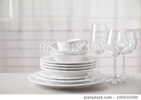 Set of clean tableware on light grey marble table Set of clean tableware on light grey marble table 140910300
