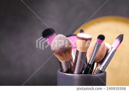 Set of professional makeup brushes in holder, closeup Set of professional makeup brushes in holder, closeup 140910306