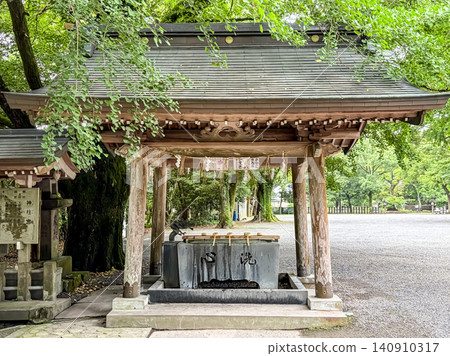 The purification fountain at the Kamihashira Shrine where you cleanse your hands before praying. The purification fountain at the Kamihashira Shrine where you cleanse your hands before praying. 140910317