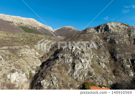 Rugged limestone rock formations under blue sky in Apennines mountains 140910569